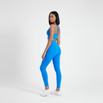 Blue sports bra and leggings on a plain background- Aresfit
