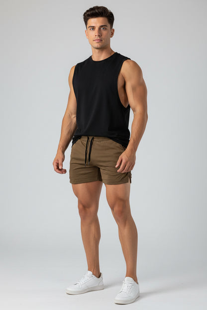 Brown shorts worn by a person on a white background