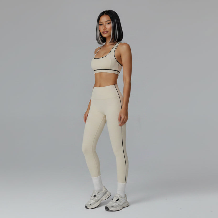 Person wearing a beige sports bra and leggings set on a white background - Aresfit