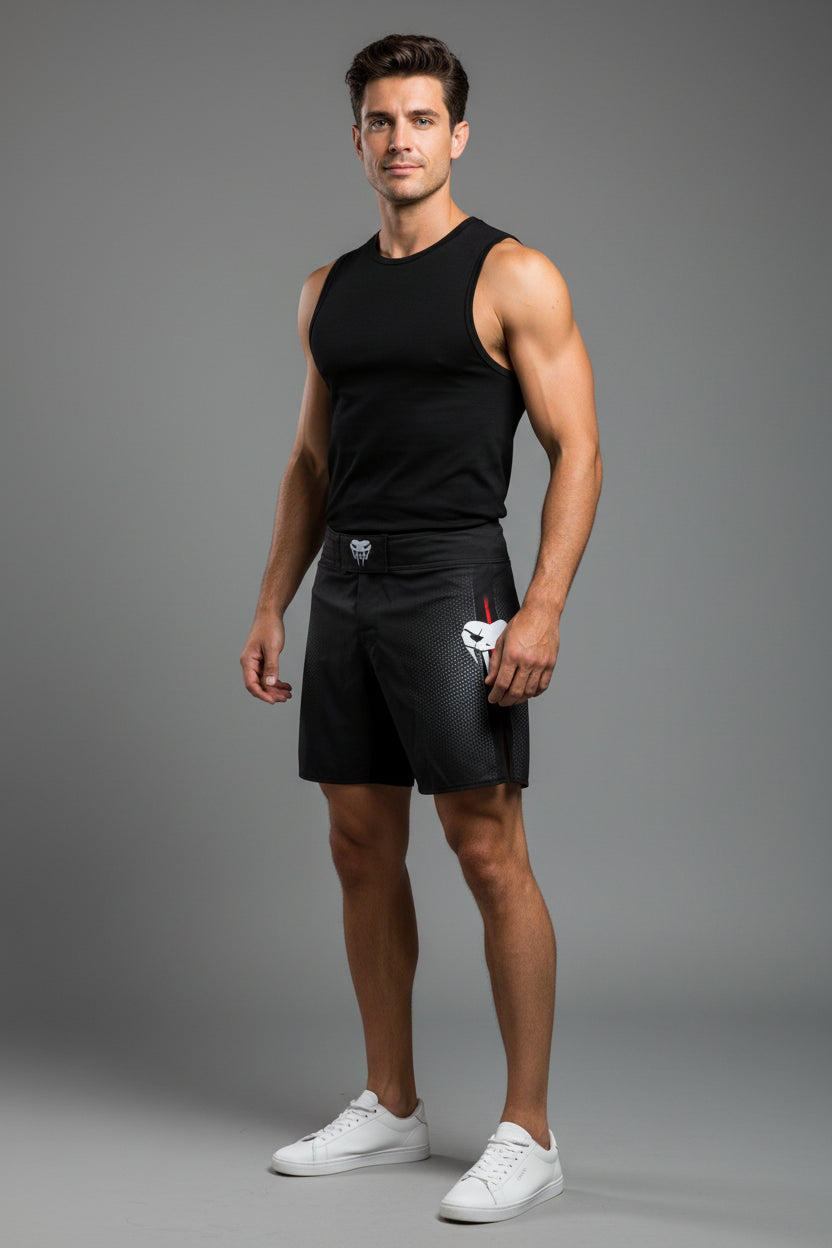 Black athletic shorts with a logo on a white background