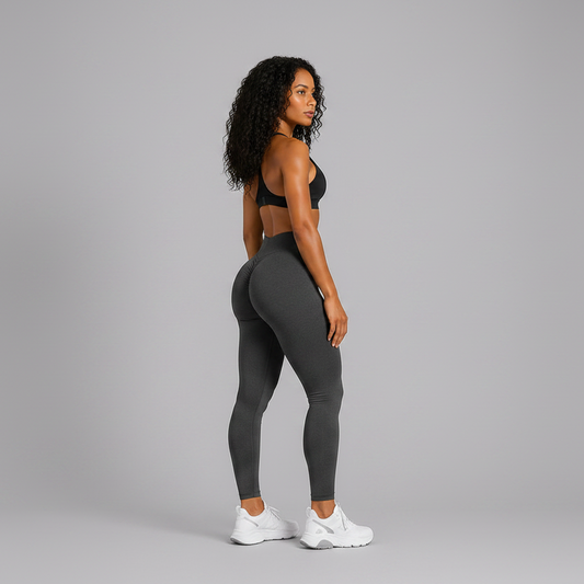 Person wearing a black sports bra and gray leggings on a gray background - Aresfit