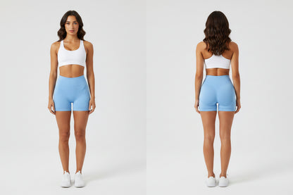 Woman wearing butt lifting shorts light blue with a white sports bra - Aresfit
