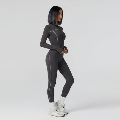Person wearing a gray full-body suit on a light gray background - Aresfit