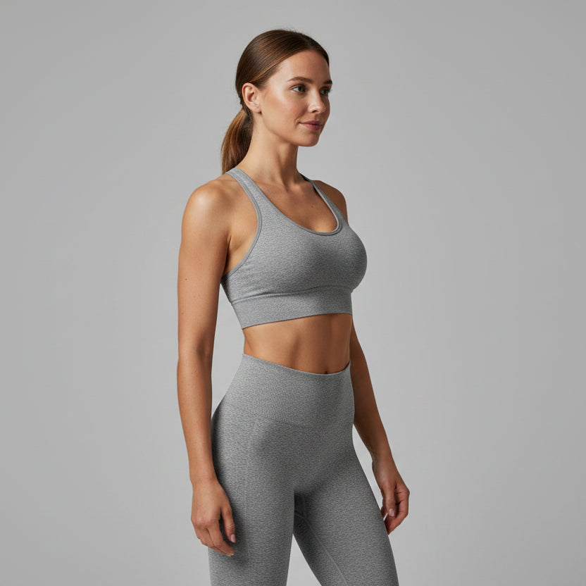 Woman wearing a gray sports bra on a white background - Aresfit