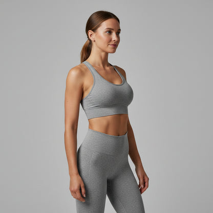 Woman wearing a gray sports bra on a white background - Aresfit
