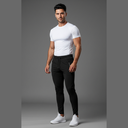 Man wearing a white t-shirt and black pants on a gray background