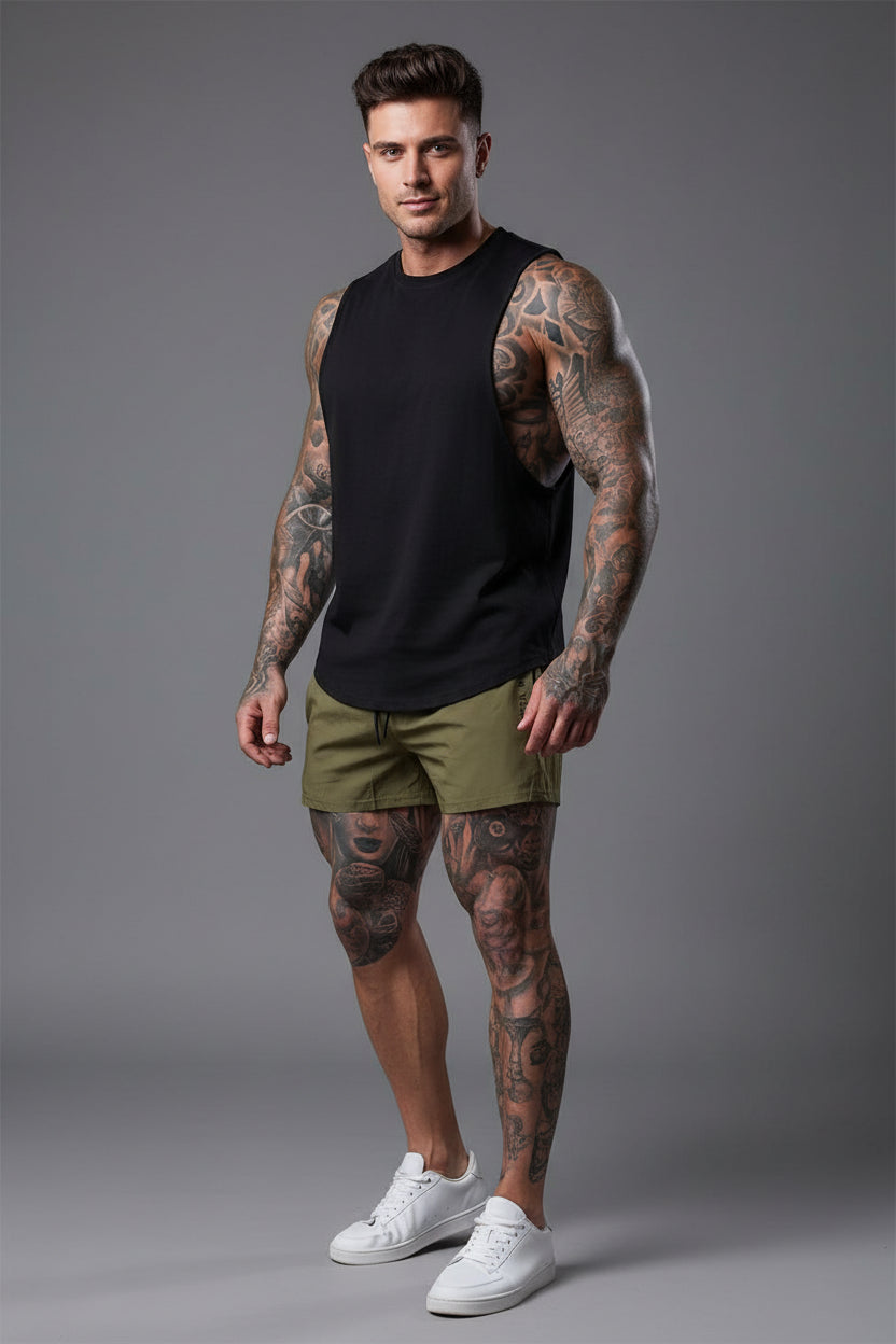 Person wearing green shorts with 'Gym Wear' text, standing against a brick wall.