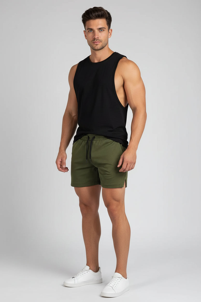 Person wearing green shorts with a white background