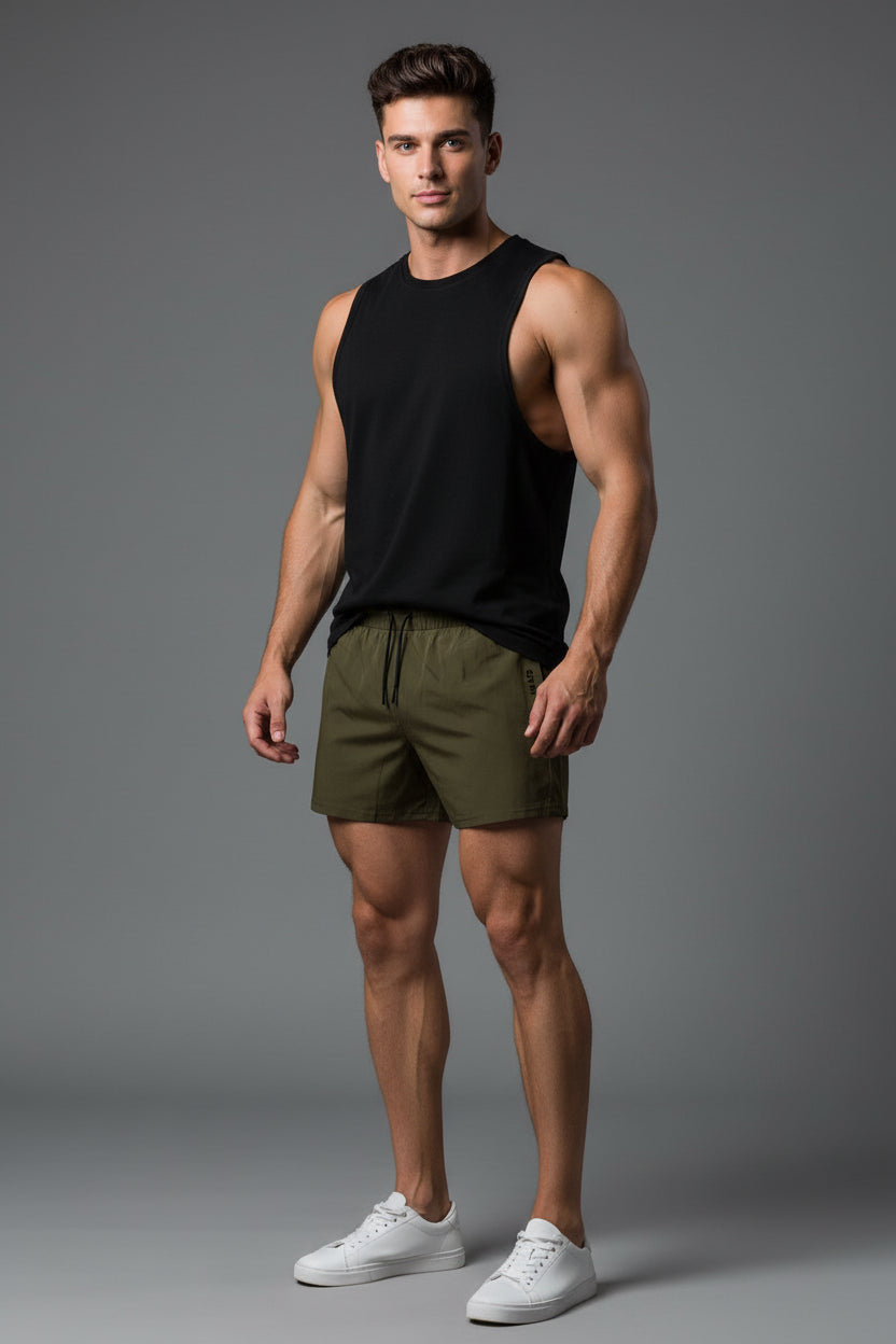 man wearing olives shorts and a black tank top