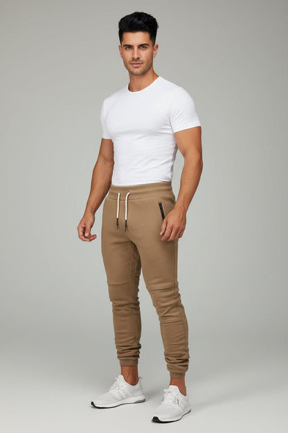 Man wearing beige gym jogger pants and white fitted t-shirt
