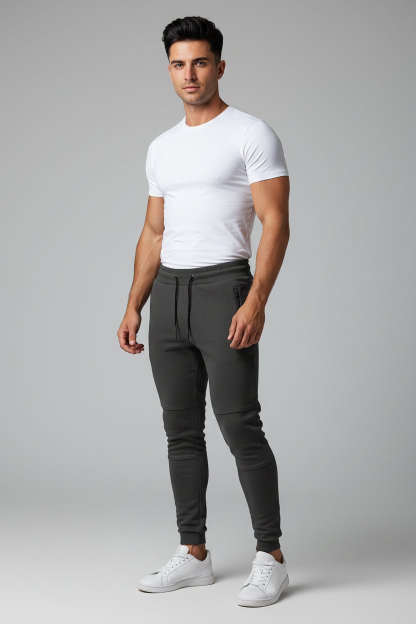 Man wearing dark grey gym jogger pants and white fitted t-shirt