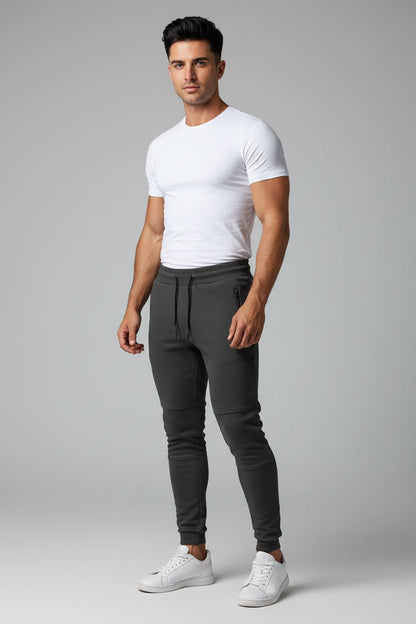 Man wearing dark grey gym jogger pants and white fitted t-shirt
