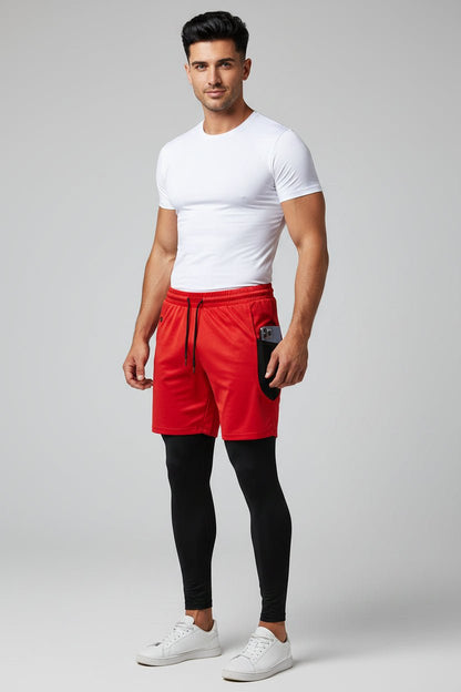 Man wearing a white t-shirt, red shorts, and black leggings on a light gray background