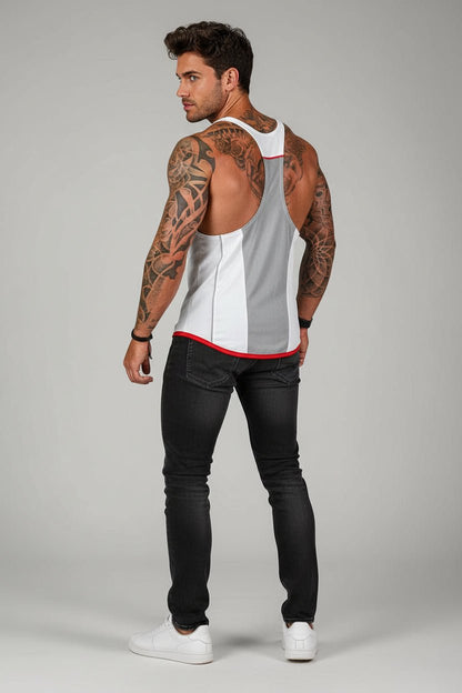 Man wearing a white tank top with red trim and black pants on a gray background