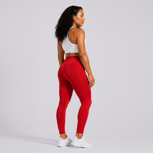 Person wearing a white sports bra and red leggings on a light gray background - Aresfit