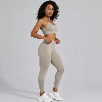 Woman wearing a beige seamless sports bra and high waist leggings set on a gray background - Aresfit