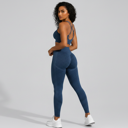 Woman wearing a blue seamless sports bra and high waist leggings set from the back on a gray background - Aresfit