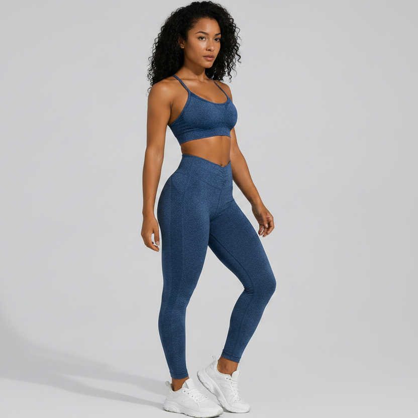 Woman wearing a blue seamless sports bra and high waist leggings set on a gray background - Aresfit