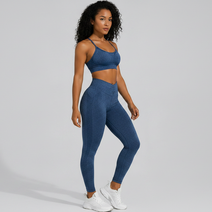 Woman wearing a blue seamless sports bra and high waist leggings set on a gray background - Aresfit