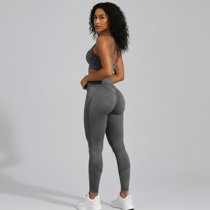 Woman wearing a gray seamless sports bra and high waist leggings set from the back on a gray background - Aresfit