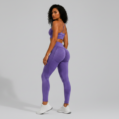 Woman wearing a purple seamless sports bra and high waist leggings set from the back on a gray background - Aresfit