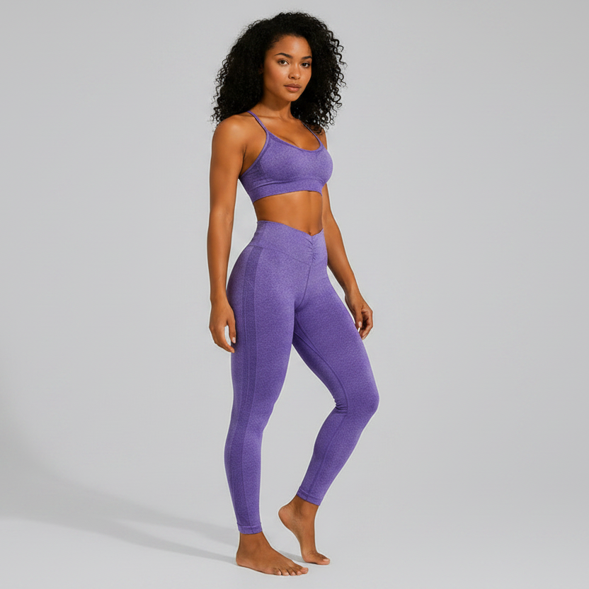 Woman wearing a purple seamless sports bra and high waist leggings set on a gray background - Aresfit
