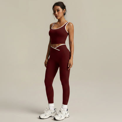 Woman wearing a maroon athletic outfit with white sneakers on a neutral background- AresFit