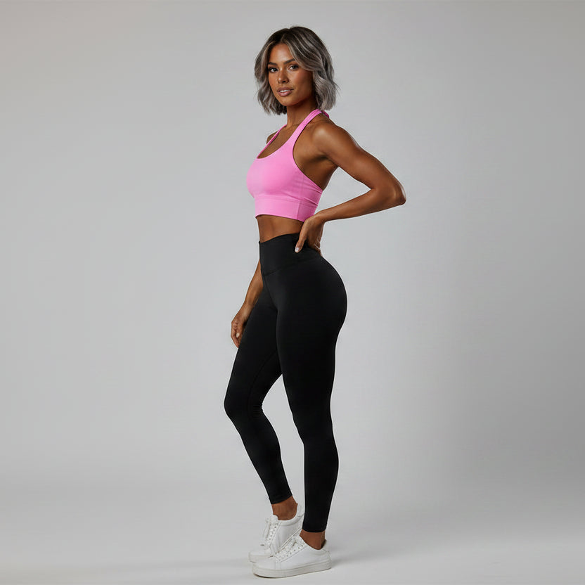 Side view of women’s pink halter neck gym top with stretch activewear fit - AresFit