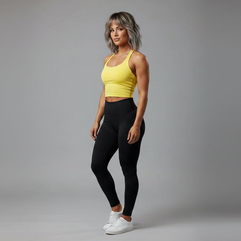 Women’s yellow halter neck gym top with fitted seamless activewear style - AresFit