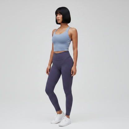 Gray women’s seamless cross back sports bra with breathable athletic fit - AresFit